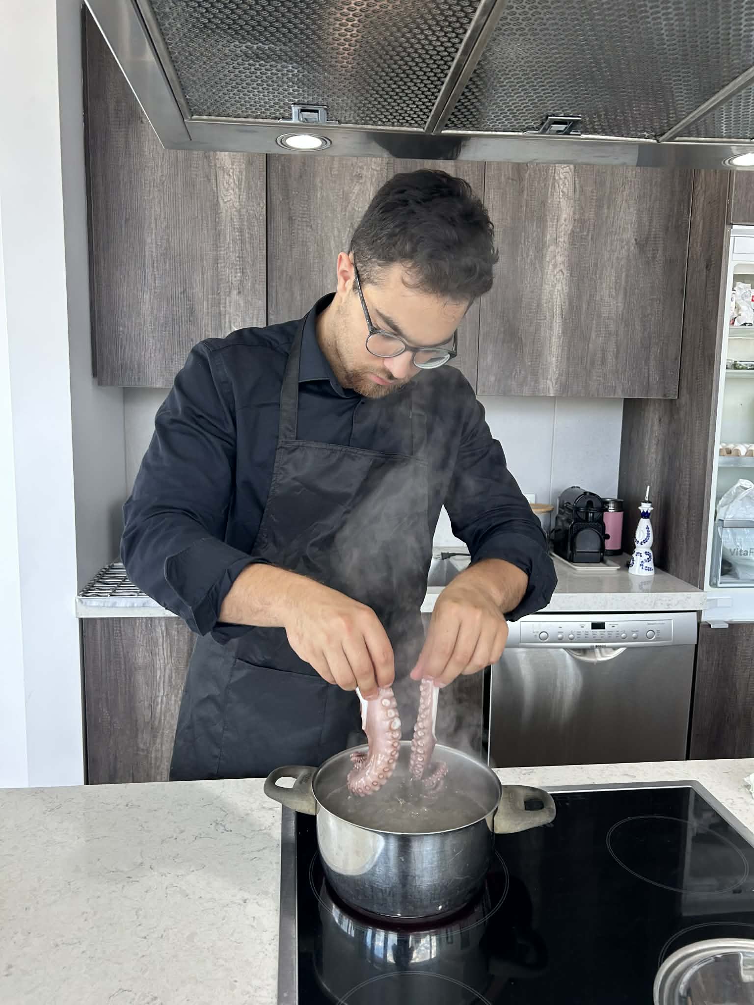 Chef Neil preparing octopus tableside during service