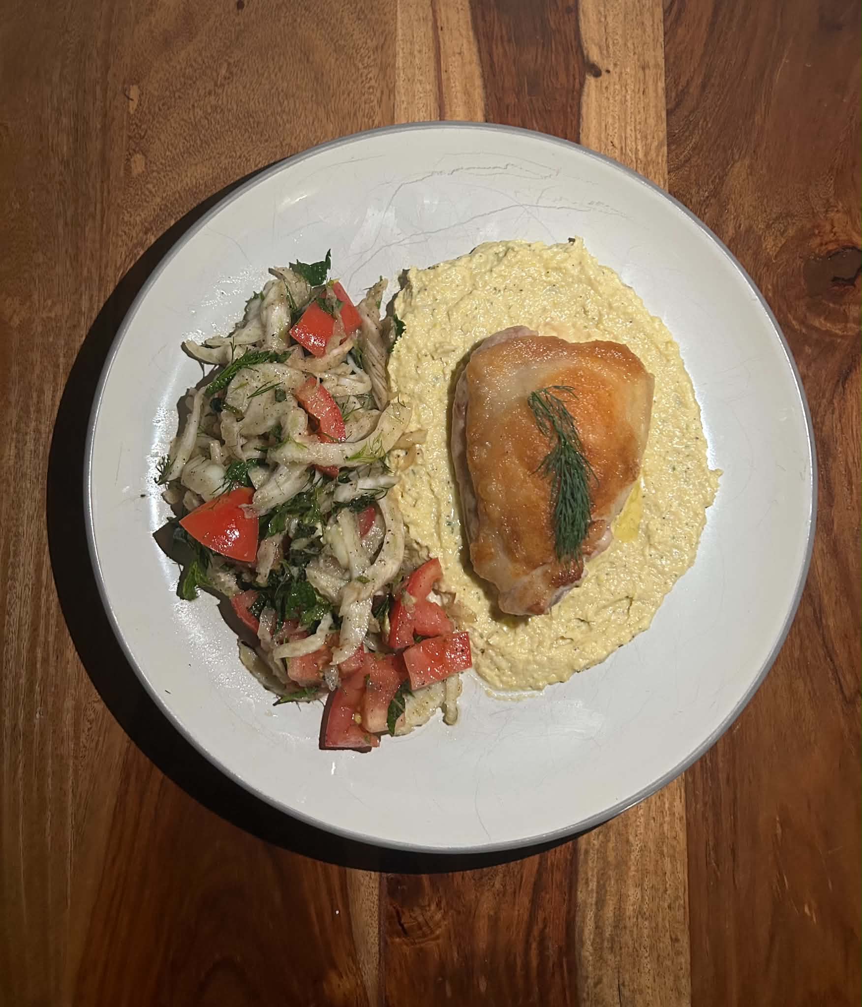 Roasted chicken over creamy polenta with fennel tomato salad