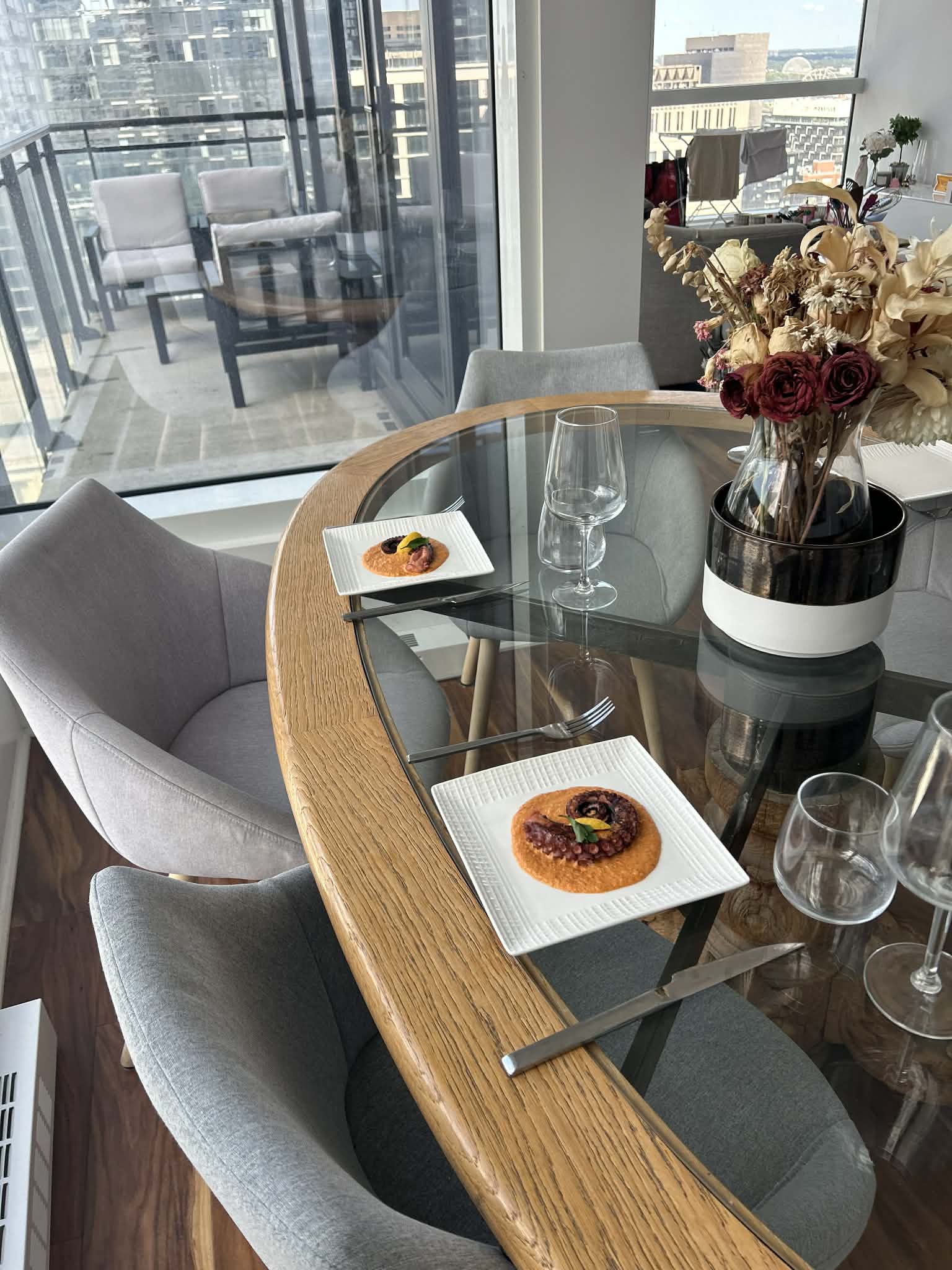 Two plated octopus courses set at a table